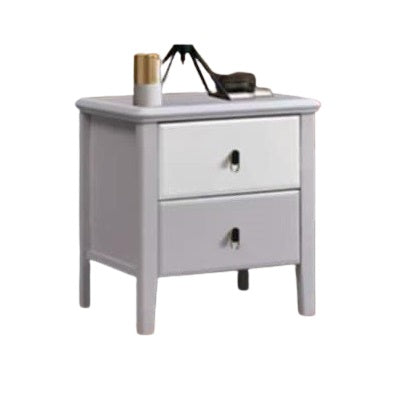 A bedside table adorned with a clock and several photographs, enhancing the room's intimate and inviting ambiance.