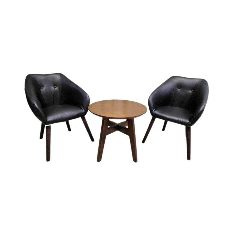 Two stylish black leather chairs with a table in between, offering a modern and inviting seating arrangement.