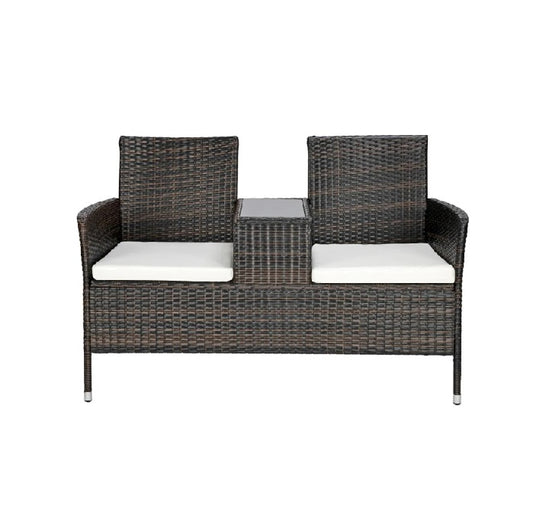 Outdoor rattan sofa set featuring plush cushions, perfect for relaxing in a garden or patio setting.