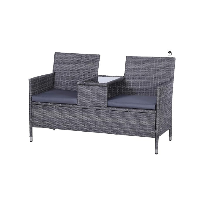 Outdoor rattan sofa set featuring plush cushions, perfect for relaxing in a garden or patio setting.