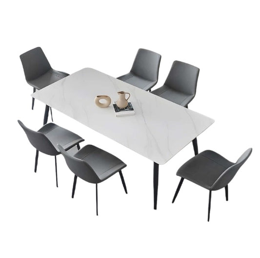 A modern dining table with matching chairs, designed for comfort and social dining experiences.