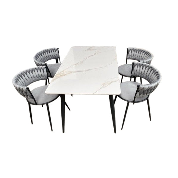A stylish dining set featuring a table surrounded by elegant chairs, perfect for family meals and gatherings.
