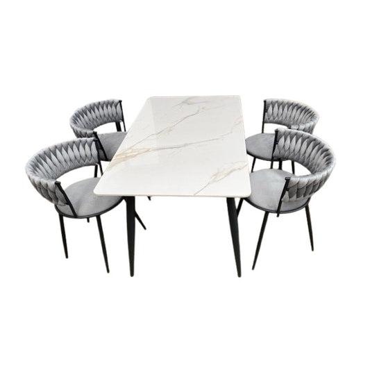 A stylish dining set featuring a table surrounded by elegant chairs, perfect for family meals and gatherings.