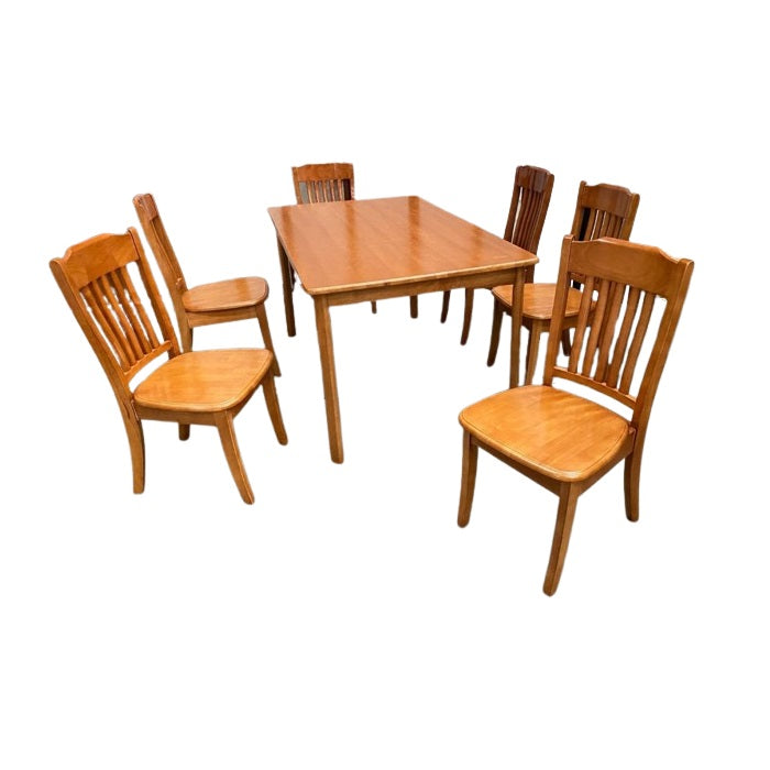 A modern dining table with matching chairs, designed for comfort and social dining experiences.
