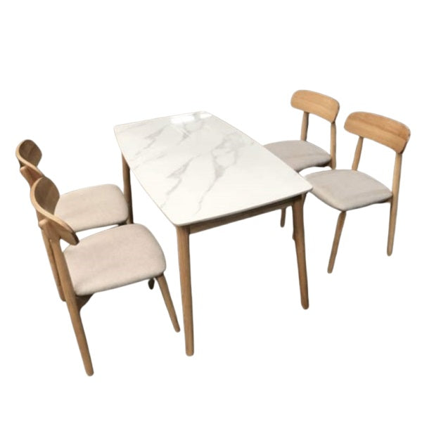 A white marble table surrounded by four elegant chairs, creating a sophisticated dining area.