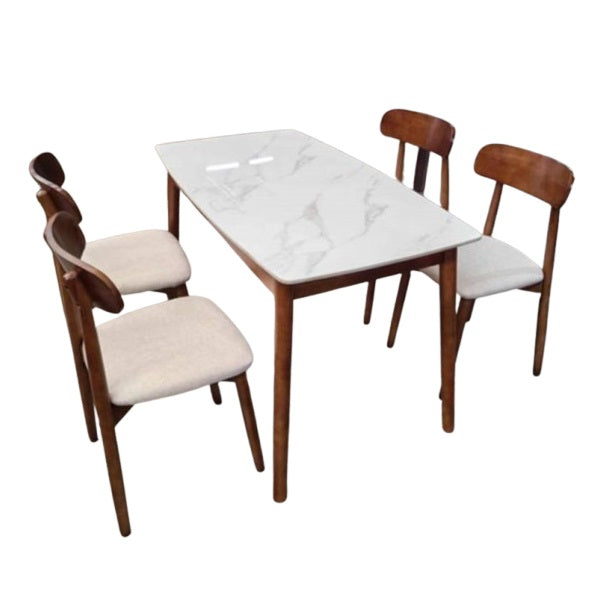 A white marble table surrounded by four elegant chairs, creating a sophisticated dining area.