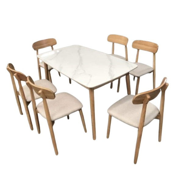 A white marble table surrounded by six elegant chairs, creating a sophisticated dining area.
