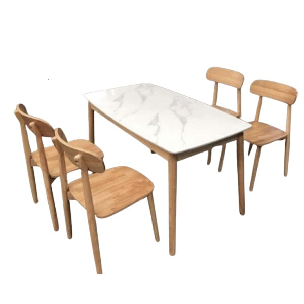 A white marble table surrounded by four elegant chairs, creating a sophisticated dining area.
