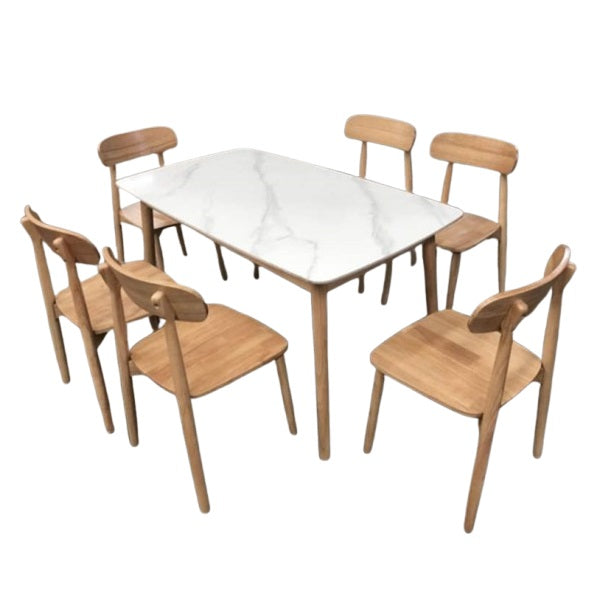 A white marble table surrounded by six elegant chairs, creating a sophisticated dining area