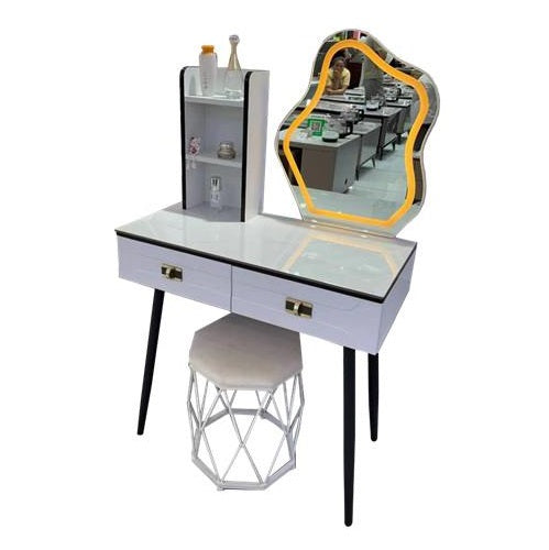 A dressing table featuring a mirror and a matching stool, elegantly arranged for personal grooming and styling.