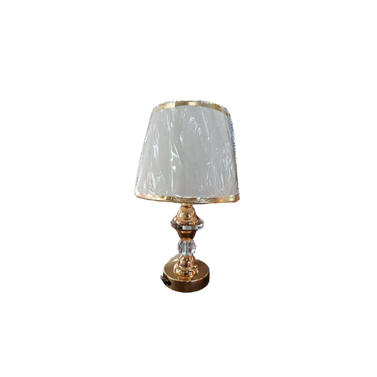 A gold table lamp featuring a white shade, elegantly designed for stylish lighting in any room.