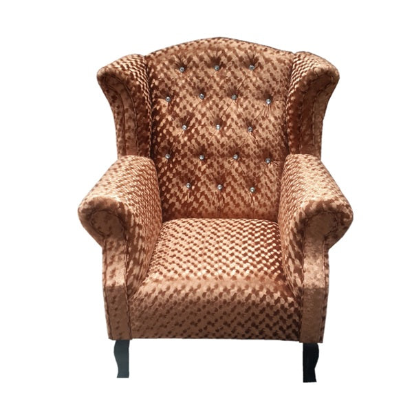 An elegant brown velvet chair adorned with a diamond button, highlighting its sophisticated style.