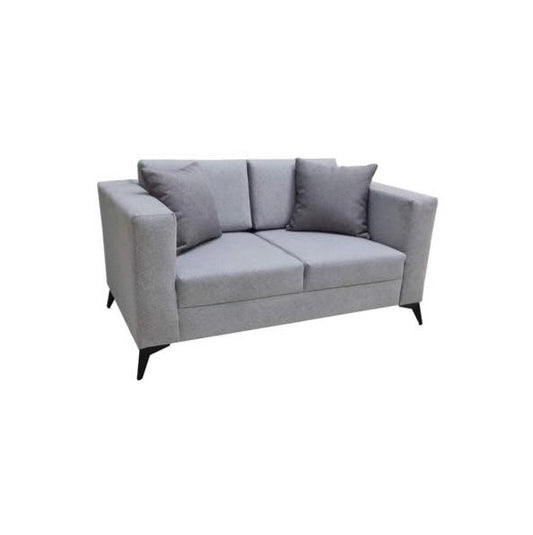 A modern grey couch with two accent pillows, offering a chic and comfortable seating option.