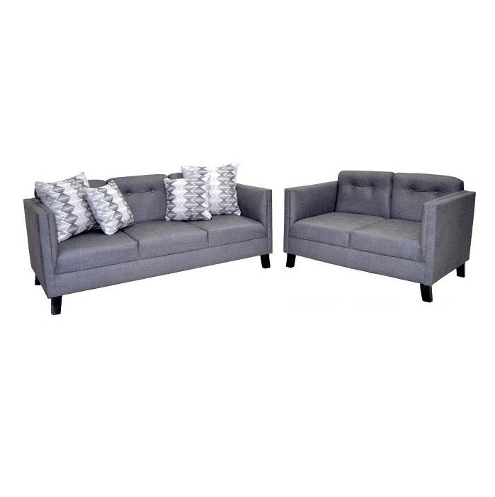 A cozy living room featuring two GRAY leather couches alongside a complementary loveseat.