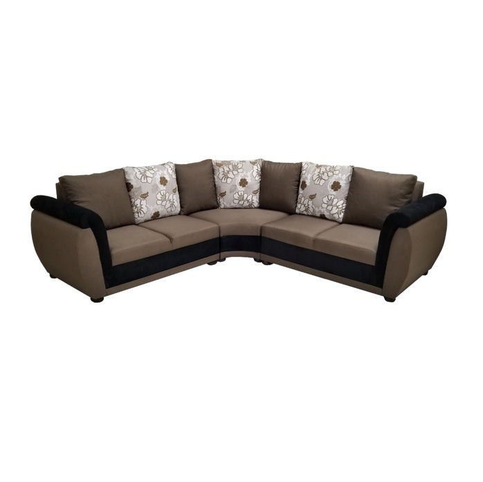 A stylish sectional couch featuring a mix of brown and white pillows, enhancing the comfort of the room.