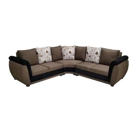 A stylish sectional couch featuring a mix of brown and white pillows, enhancing the comfort of the room.