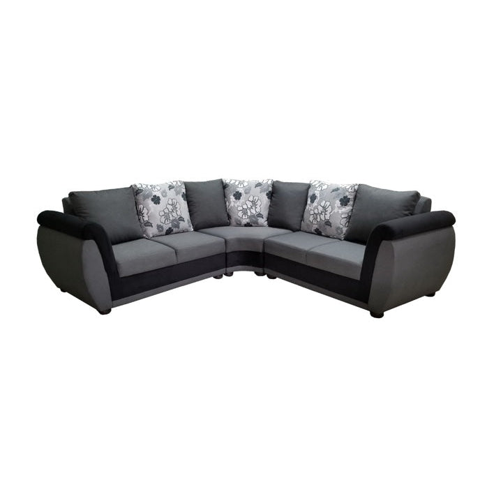 A stylish sectional couch featuring a mix of brown and white pillows, enhancing the comfort of the room.