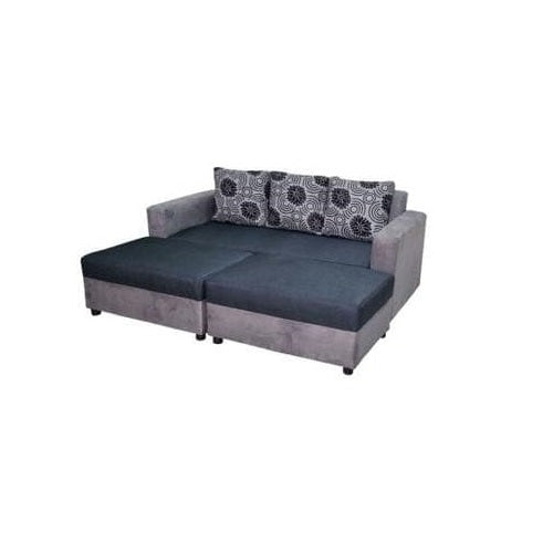 A gray sectional couch adorned with decorative pillows, offering a cozy and inviting living space.