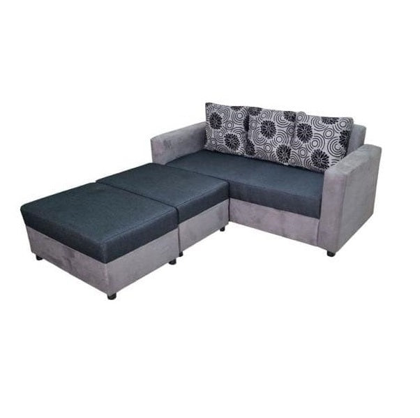 A gray sectional couch adorned with decorative pillows, offering a cozy and inviting living space.