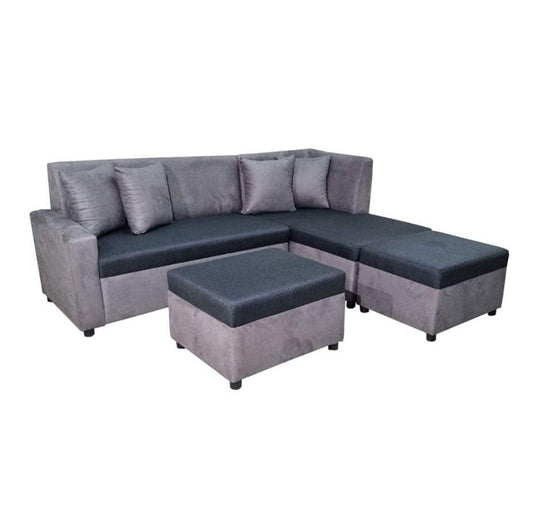 A stylish grey sectional couch featuring decorative pillows and ottomans, enhancing the comfort of the room.