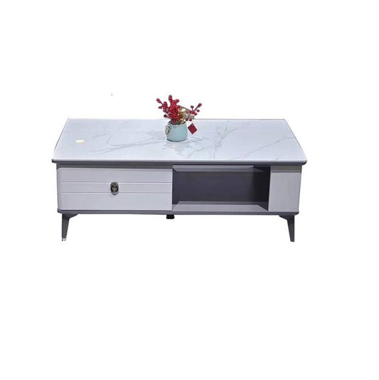 A minimalist white coffee table with a vase, creating a chic and inviting atmosphere.