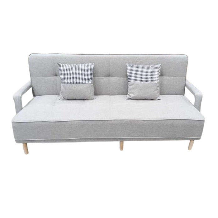 A sleek grey leather sofa featuring plush pillows, enhancing the elegance and comfort of the living space.