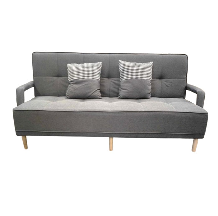 A sleek grey leather sofa featuring plush pillows, enhancing the elegance and comfort of the living space.