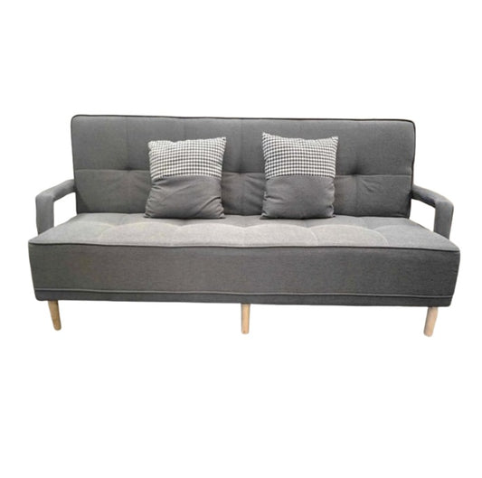 A sleek grey leather sofa featuring plush pillows, enhancing the elegance and comfort of the living space.