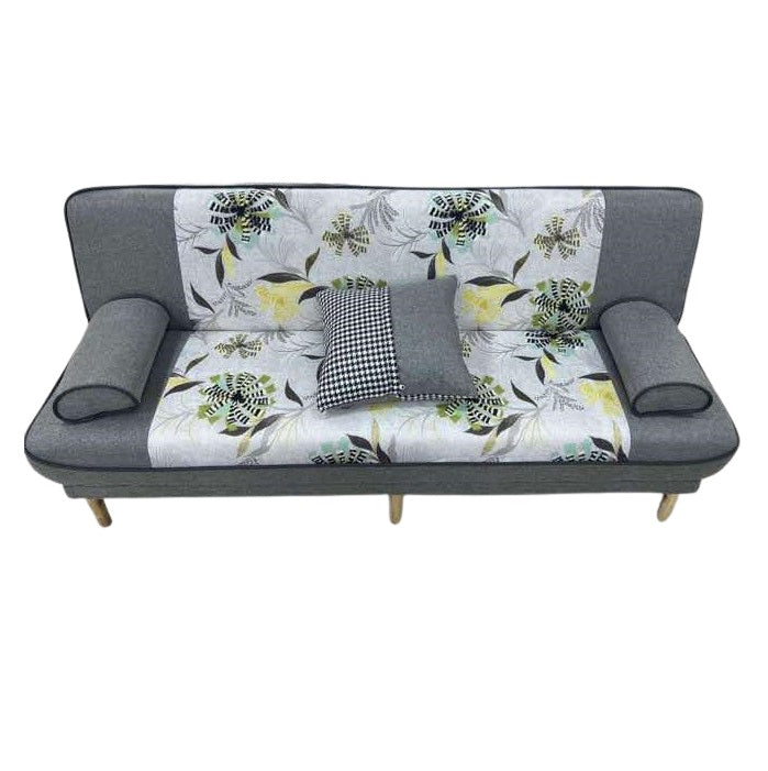 A stylish couch featuring a colorful floral design, enhancing the room's aesthetic appeal.